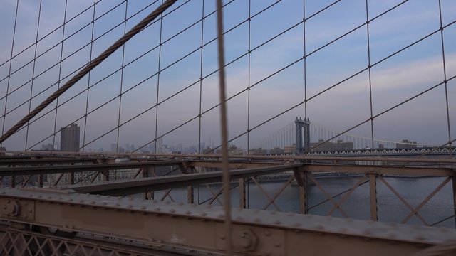 NEW YORK - Circa December, 2015 - A personal perspective walking over the Brooklyn Bridge headed to lower Manhattan.	 	