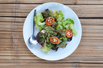 serving of healthy vegetables salad on bamboo