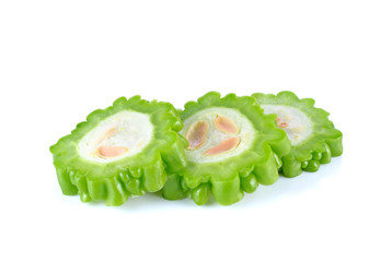 slices of bitter gourd arranged on white background