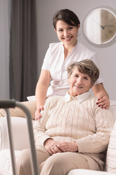 Disabled elderly woman and caregiver