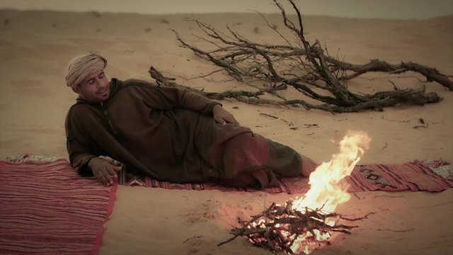 sahara man singing near a fire, including audio