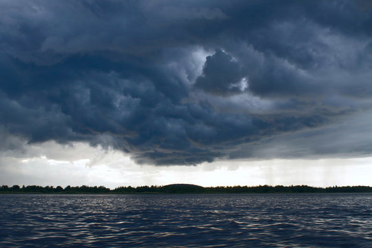 Storm clouds gathering over the forest, view from the sea (the White Sea, the village Kolezhma)