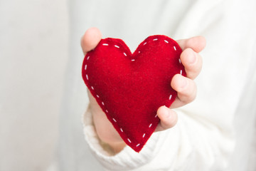 Female hand with red heart