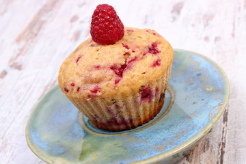 Fresh baked cupcake with raspberries and chocolate, delicious dessert
