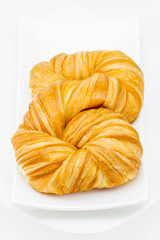 Fresh and tasty croissant on white background