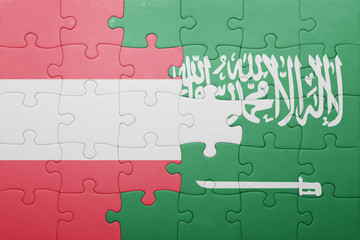 Fototapeta premium puzzle with the national flag of saudi arabia and austria