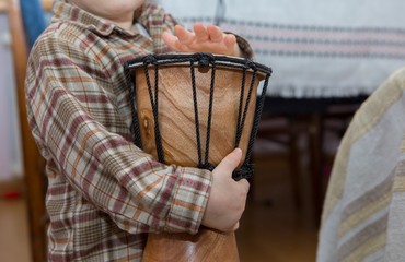 Small child playing on drum