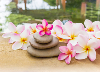 Fototapeta na wymiar Flower plumeria or frangipani sweet decorated on pebble rock in