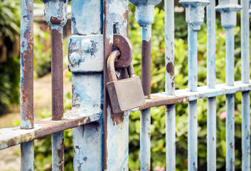 Old rusted lock on blue rusty iron gate, Close up and selective focus