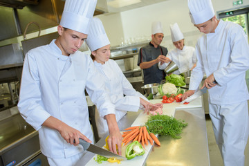 Team of chefs preparing vegetables