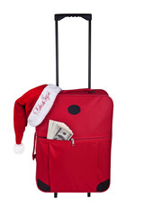 The suitcase of the tourist dollars and a cap of Santa Claus