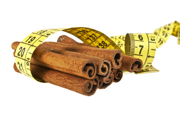 Cinnamon sticks wrapped roulette on a white background