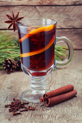 Christmas mulled wine in glass cup on wooden background