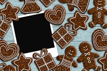 photos lying on wooden desk with gingerbread couple
