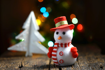 Still life of Snowman with bokeh lights in the background.
