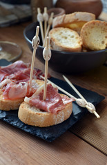 appetizer of ham Serrano with bread roasted