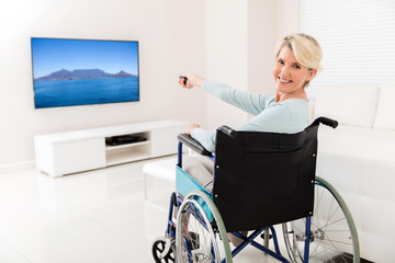 handicapped mid age woman watching tv