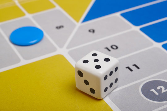 Parcheesi board game detail with dice and game piece
