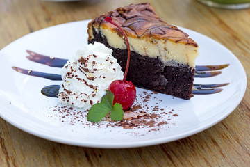 Chocolate Cake with cream cheese on a wood background