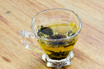 Cup with green tea on wooden background