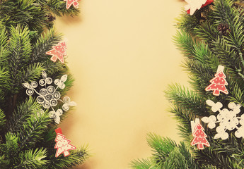 Fototapeta na wymiar Christmas fir tree branches with toys on paper background