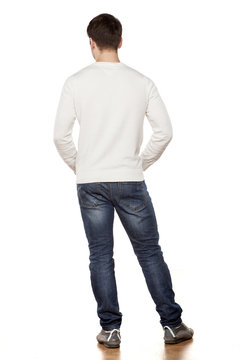 Handsome Young Man Posing In Jeans From The Back