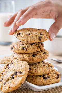 close up of hand taking cookie from stack 