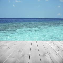 Fototapeta na wymiar Wooden pier with beautiful sea or ocean background