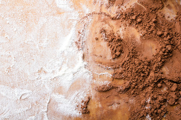 Obraz premium flour and cocoa on a wooden pastry board