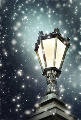 Fototapeta na wymiar Vintage street lamp, falling snow, night