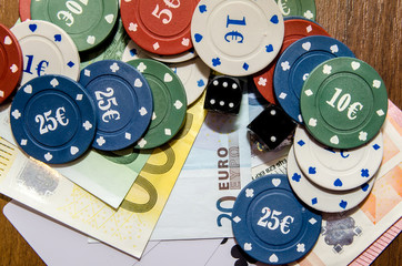 poker chips with playing card, euro note as background