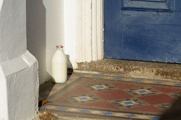 Glass pint milk bottle outside house 