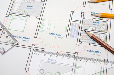 Construction planning drawings and three yellow pencils with ruler