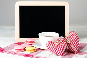 Cup of coffee and a decorative heart with a cake and plaque for writing the text on a white background isolated