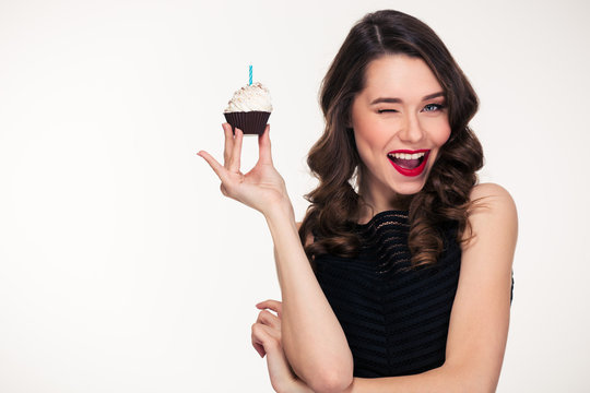 Retro Styled Woman Holding Birthday Cupcake With Candle And Winking