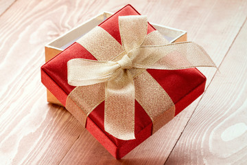 Gift box with golden ribbon and bow