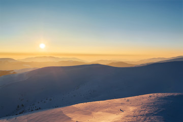 Fototapeta na wymiar Beautiful sunset in mountains. Winter landscape.
