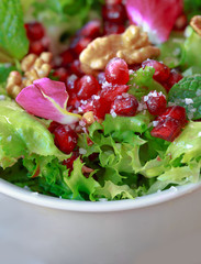 Close up of curly endive salad with pomegranate, nuts...