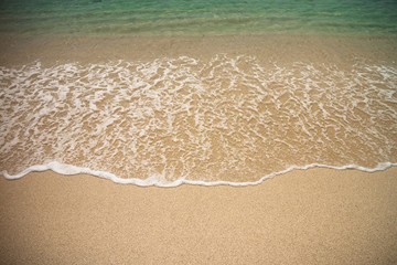 Wave of the sea on sand of beach