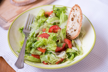salad with lettuce leaves, cucumber and tomatoes