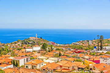Fototapeta na wymiar South coast of Funchal -view over the capital city of Madeira, district Sao Martinho with civila parish church. View from Pico dos Barcelo - Atlantic Ocean in the background.