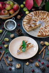 Slice of homemade apple pie with fresh apples