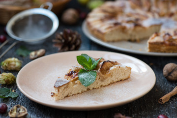 Slice of homemade apple pie with fresh apples