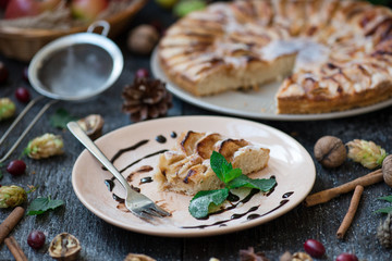 Slice of homemade apple pie on wooden table