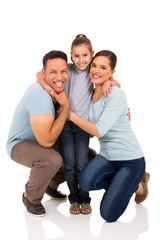 little girl hugging her parents