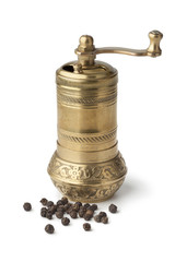 Traditional oriental pepper mill and black pepper