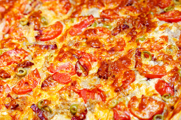 Delicious juicy pizza homemade closeup background.