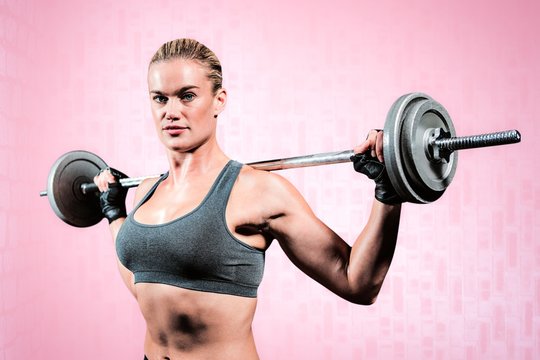 Composite image of muscular woman lifting heavy barbell 