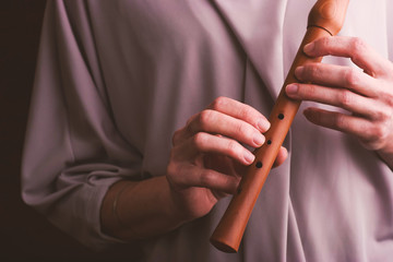 Flute in the woman hands horizontal