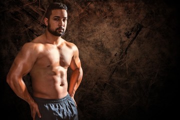 Fototapeta premium Composite image of portrait of confident bodybuilder man
